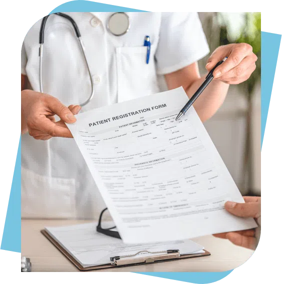 Dentist showing a patient registration form to a new patient