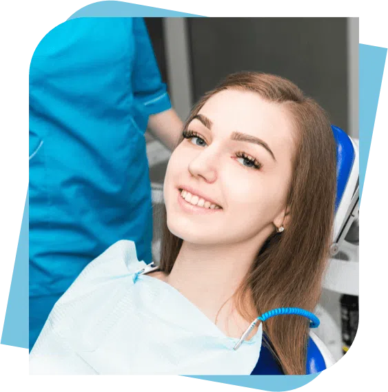 teenage girl smiling while sitting in a dental chair.