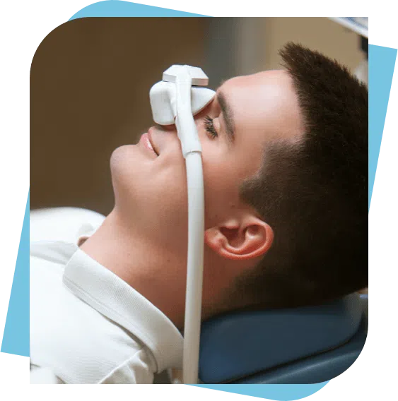 man looking at ease while wearing a nitrous oxide mask at the clinic