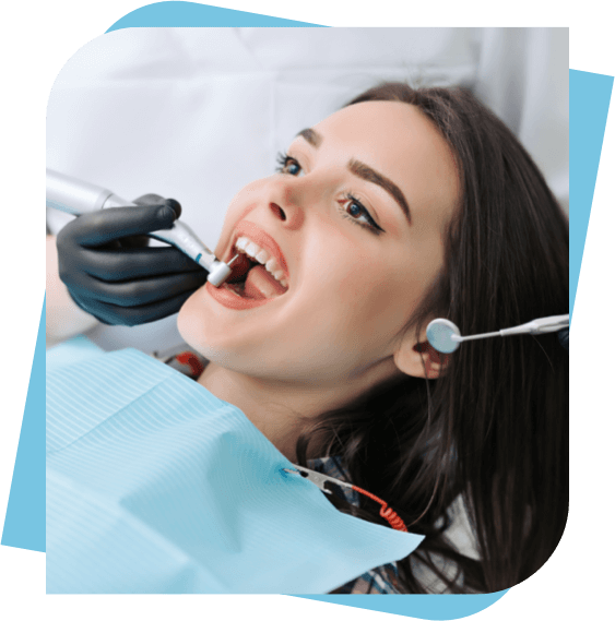Woman having her teeth cleaned by her dentist