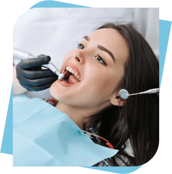 Woman having her teeth cleaned by her dentist