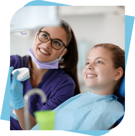 dental hygienist and a patient looking at a screen after teeth cleaning