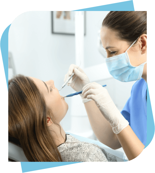 dental hygienist cleaning a woman's teeth