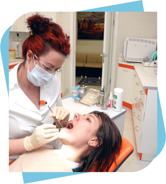 Female dentist performing a procedure on a sedated patient.