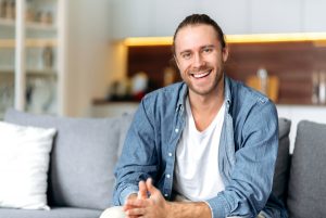 man smiling in his home with white smile