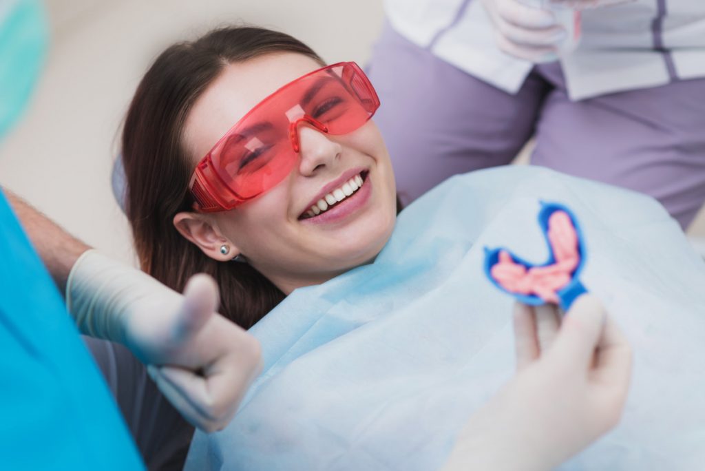 dental patient receiving fluoride treatment at dental clinc
