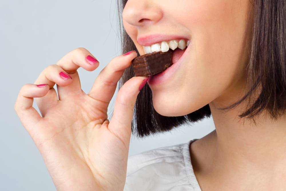 A girl eating a brownie
