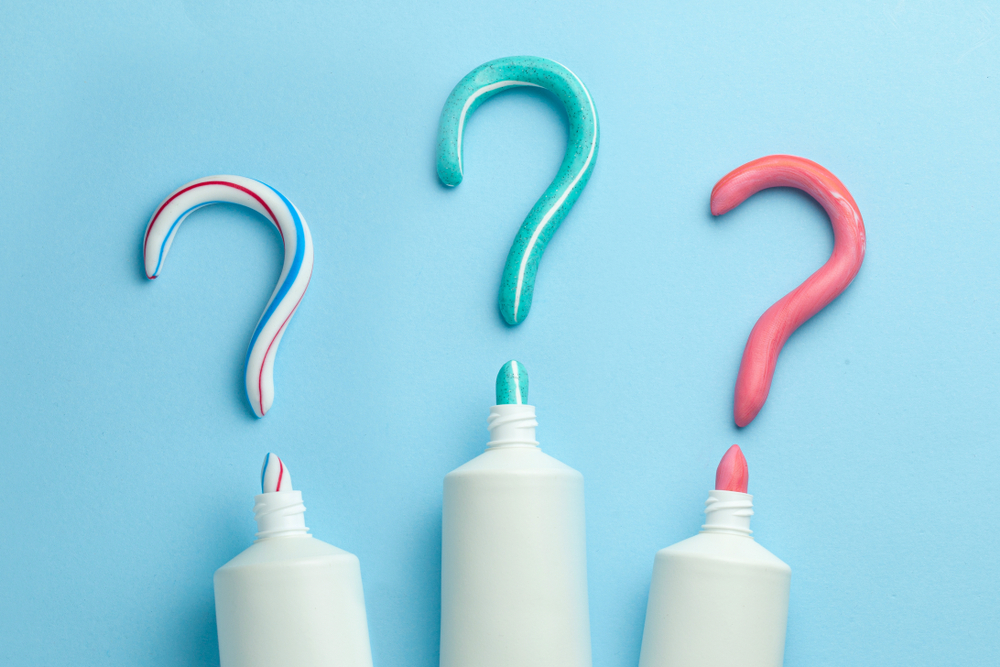 Three different toothpaste bottles with question marks.